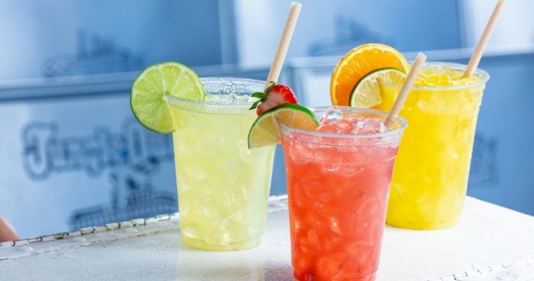 Three colorful cocktails with ice and fruit garnishes. Junglequeen Ignite The Night Isle Dinner Show With S Colorful Drinks Cocktails Ice Fruit