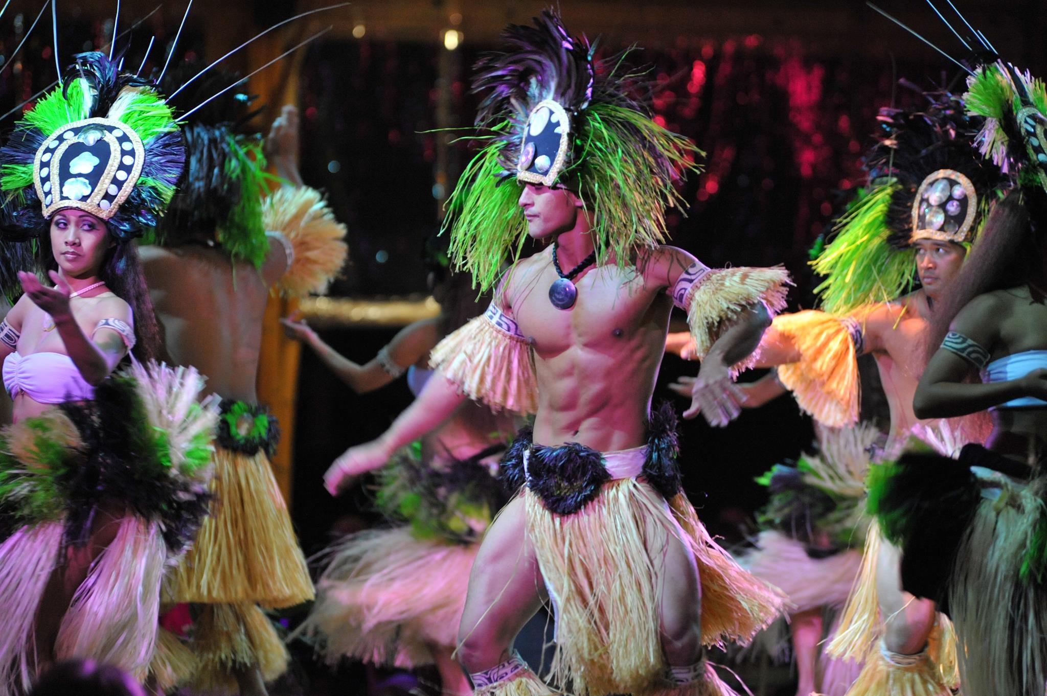 Dancers in traditional Hawaiian costumes perform with vibrant headdresses. Luau Kalamaku Hawaiian Package Hawaiian Luau Dancers Costumes