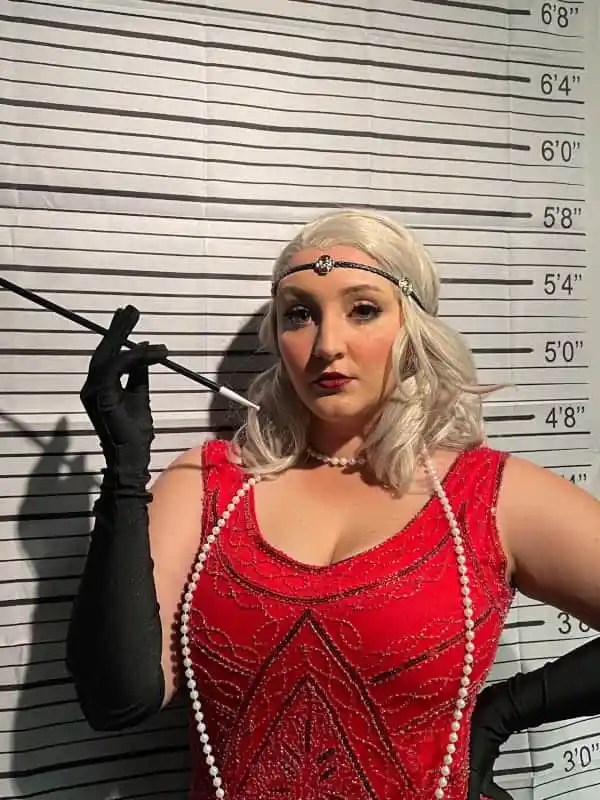 Rigatonysdinnershow Riga Tony S Murder Mystery Flapper Red Dress Gloves Mugshot Background