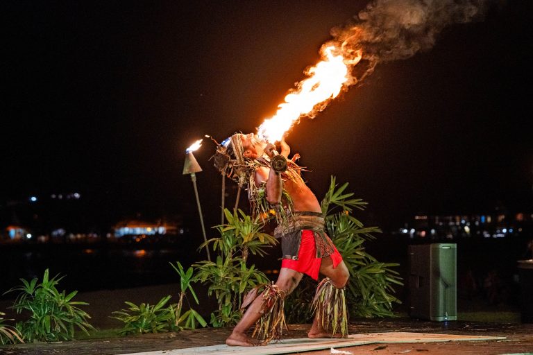 A performer breathes fire during a Polynesian dance show at night. Royalsonestaluau Drums Dances Of Polynesia At The Royal S Fire Breather Polynesian Dance Night