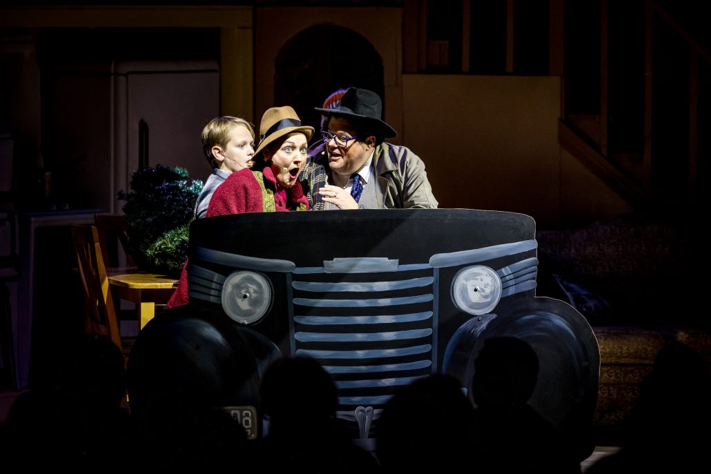 Three performers act surprised while sitting in a painted car. Theshepherdofthehills A Christmas Story Dinner Show Dinner Show Theater Performance Car