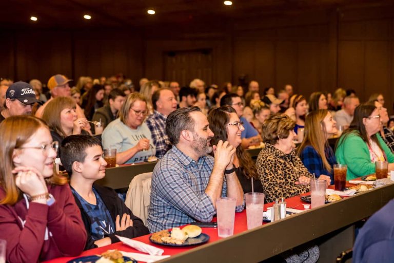 A diverse audience enjoying a dinner show, smiling and engaged. Theshepherdofthehills Branson S Whodunnit Hoedown Murder Myste Audience Dinner Show Laughter