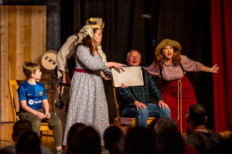 Actors perform a lively scene on stage during a dinner show. Theshepherdofthehills Branson S Whodunnit Hoedown Murder Myste Dinner Show Mystery Performance A