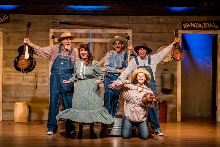 Five performers in costumes pose with musical instruments on stage. Theshepherdofthehills Branson S Whodunnit Hoedown Murder Myste Murder Mystery Dinner Show Perfor