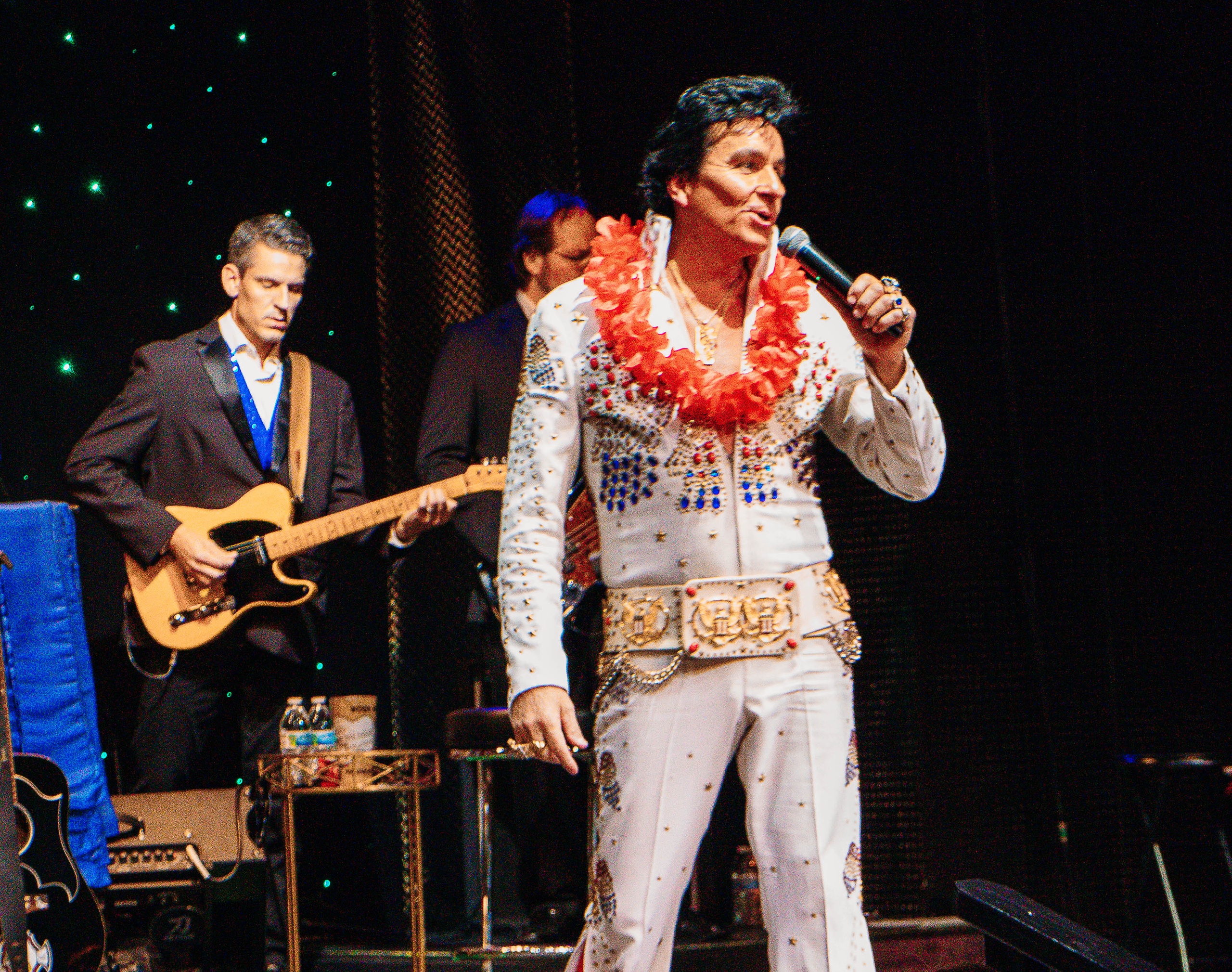 An Elvis impersonator sings on stage while a guitarist plays behind him. Toddherendeentheatre Todd Herendeen S Rock Country Legends Sh Elvis Impersonator Guitarist Stage